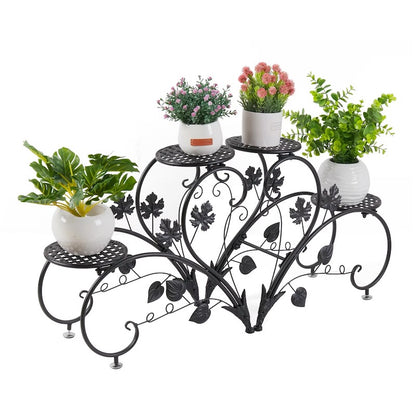 Decorative metal plant stand with potted plants on a white background