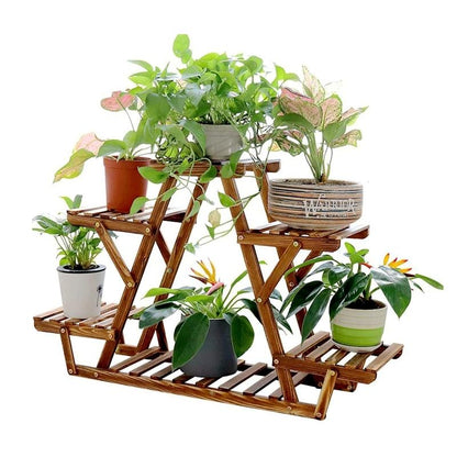 Wooden plant stand with multiple shelves holding various potted plants on a white background