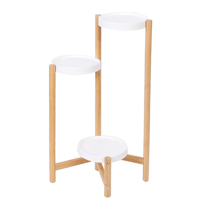 Three-tier bamboo plant stand in a white background